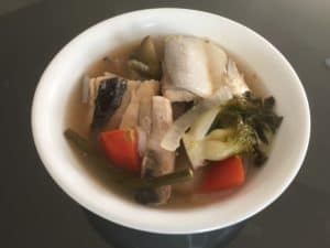 Sinigang na bangus belly is a traditional Filipino soup dish made with milkfish belly, vegetables, and tamarind broth. The fish belly is typically the most prized part of the milkfish due to its tender, fatty meat. The dish gets its tangy flavor from tamarind, which is used to make the sour broth.