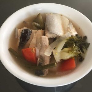 Sinigang na bangus belly is a traditional Filipino soup dish made with milkfish belly, vegetables, and tamarind broth. The fish belly is typically the most prized part of the milkfish due to its tender, fatty meat. The dish gets its tangy flavor from tamarind, which is used to make the sour broth.