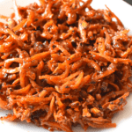 Sweet and spicy dilis is a Filipino fried snack. It consists of small anchovies deep fried with banana ketchup, sugar, and cayenne pepper powder.