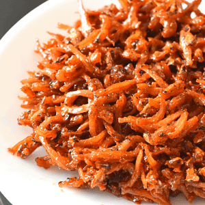 Sweet and spicy dilis is a Filipino fried snack. It consists of small anchovies deep fried with banana ketchup, sugar, and cayenne pepper powder.