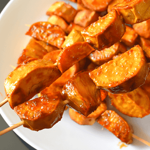 Kamote Que, also known as camote cue or sweet potato fritters, is a popular snack in the Philippines. It is made by deep-frying slices of sweet potatoes coated in brown sugar and skewered on bamboo sticks.