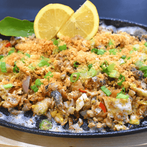 Bangus Sisig is a Filipino dish made from milkfish (bangus) that has been deboned, flaked, and cooked with various ingredients such as onions, garlic, chili peppers, and mayonnaise. It is typically served on a sizzling plate and topped with a raw egg for added creaminess.