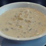 Clam chowder is a type of soup that originated in New England and is made with clams, broth or milk, potatoes, onions, and other ingredients such as bacon or salt pork. It can also include seasonings like thyme or bay leaves.