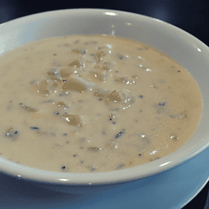 Clam chowder is a type of soup that originated in New England and is made with clams, broth or milk, potatoes, onions, and other ingredients such as bacon or salt pork. It can also include seasonings like thyme or bay leaves.