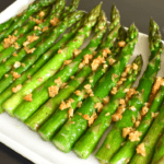 Sautéed garlic asparagus is a dish made by cooking asparagus spears in a pan with olive oil, minced garlic, salt, and pepper. The asparagus is sautéed until tender but still slightly crisp, and the garlic adds a flavorful aroma to the dish.