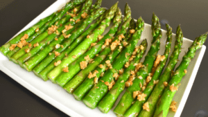 Sautéed garlic asparagus is a dish made by cooking asparagus spears in a pan with olive oil, minced garlic, salt, and pepper. The asparagus is sautéed until tender but still slightly crisp, and the garlic adds a flavorful aroma to the dish.