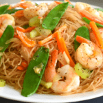 Pancit Bihon Guisado is a popular Filipino noodle dish made with thin rice noodles (bihon), sautéed with vegetables, meat and/or seafood, and flavored with soy sauce, citrus juice, and other seasonings. It is commonly served as a main dish or as a side dish in celebrations and special occasions in the Philippines.