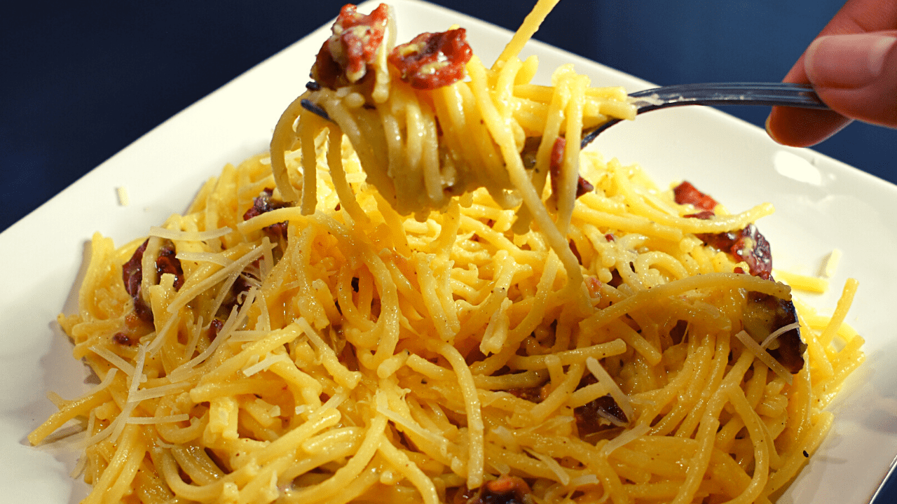 Spaghetti Carbonara is an Italian pasta dish made with spaghetti, eggs, Parmesan cheese, pancetta or bacon, and black pepper. The traditional recipe does not include cream but some variations may add it.