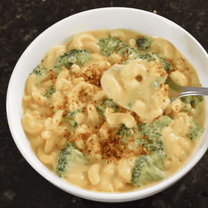 Mac and cheese with broccoli is a classic American dish typically made by combining macaroni pasta with a creamy cheese sauce and fresh or cooked broccoli.