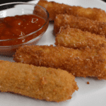 Mozzarella sticks are cheese coated in flour, eggs, and seasoned breadcrumbs, then deep fried until golden brown and crispy. It is one of America's favorite cheesy snacks!
