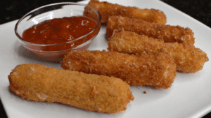 Mozzarella sticks are cheese coated in flour, eggs, and seasoned breadcrumbs, then deep fried until golden brown and crispy. It is one of America's favorite cheesy snacks!