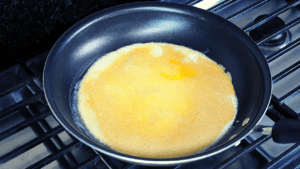 A cheese omelette is a type of dish made by beating eggs and cooking them in a pan with cheese, often folded over to form a half-moon shape. It is typically served for breakfast or brunch and may include additional ingredients such as vegetables, meats, or herbs.