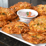 Okoy, also known as shrimp fritters, is a popular Filipino snack or appetizer made with small shrimp and vegetables mixed in a batter and then deep-fried. It is usually served with soy sauce or vinegar for dipping.