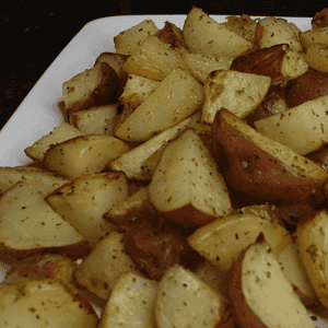 Roasted potatoes are a dish made by cooking potatoes in an oven or on a stovetop until they develop a crispy, golden-brown exterior. The potatoes are usually cut into small pieces and tossed with oil, herbs, and spices before being cooked to enhance their flavor.