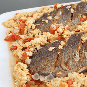 Sarciadong Tilapia is a Filipino dish made with fried tilapia fish that is smothered in a tangy tomato-based sauce. The sauce is typically made with tomato, onion, garlic, and vinegar or calamansi juice (a type of citrus fruit).