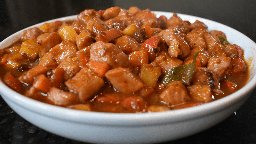 Classic Filipino dish that is hearty and flavorful. It’s made with pork, potatoes, carrots, bell peppers, onions, garlic, bay leaves and tomato sauce. The dish can be cooked in a large pot on the stovetop or in a slow cooker.