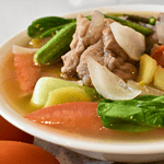 Classic Pork Sinigang is a traditional Filipino dish. It is a sour and savory soup made with slow-cooked pork meat, an array of vegetables, and tamarind, which gives the dish its distinct tangy flavor.