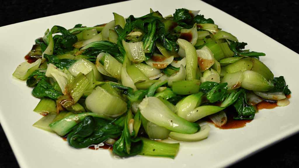 Bok choy stir fry is a popular Chinese dish made with bok choy (a type of Chinese cabbage), stir fried with various vegetables and sometimes meat or tofu. It is typically cooked in a wok or frying pan with oil, garlic, ginger, and soy sauce for flavor.