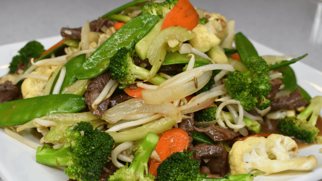 Beef chop suey is a Chinese-American stir-fry dish made with beef, vegetables, and a savory sauce. The beef is usually thinly sliced and marinated before being stir-fried with vegetables such as onions, bell peppers, and bean sprouts. The sauce typically consists of soy sauce, garlic, ginger, and other seasonings.
