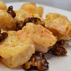 Walnut shrimp is a popular Chinese dish that consists of large, juicy shrimp coated in a sweet and creamy sauce, topped with crunchy walnuts.