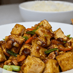 Kung pao tofu is a delicious and popular Chinese dish that originated in the Sichuan province. It is a flavorful and spicy stir-fry made with tofu, peanuts, vegetables, and a variety of sauces.