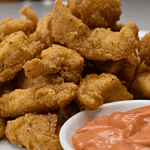 Popcorn chicken is a popular snack that originated in the United States. It consists of bite-sized pieces of chicken, typically coated in batter or breadcrumbs and then deep-fried until crispy.