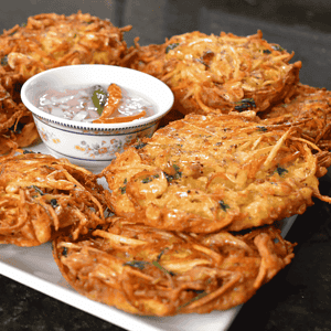 Okoy, also known as shrimp fritters, is a popular Filipino snack or appetizer made with small shrimp and vegetables mixed in a batter and then deep-fried. It is usually served with soy sauce or vinegar for dipping.