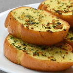 Garlic bread is a popular side dish made from sliced bread, typically baguette or Italian loaf, that has been seasoned with garlic and butter before being baked or grilled. It is a staple in Italian cuisine but has now become a beloved addition to meals all over the world.