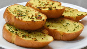 Garlic bread is a popular side dish made from sliced bread, typically baguette or Italian loaf, that has been seasoned with garlic and butter before being baked or grilled. It is a staple in Italian cuisine but has now become a beloved addition to meals all over the world.